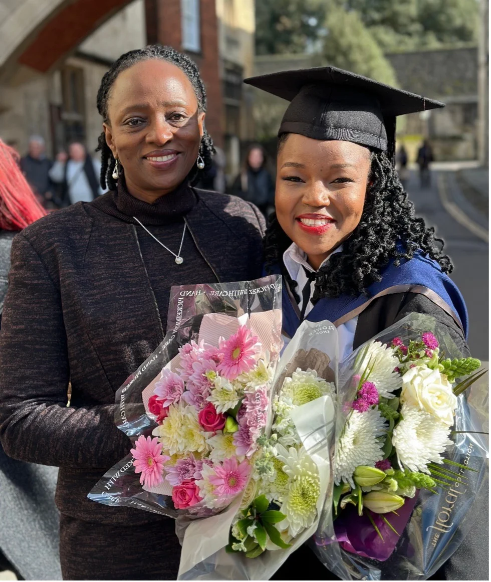 Hope Murera stands with her mentee Miriam during Miriam’s graduation at the University of Oxford as a Rhodes Scholar.